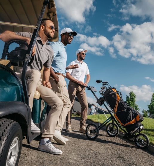 group-of-smiling-friends-standing-near-golf-cart-a-2023-11-27-05-09-35-utc